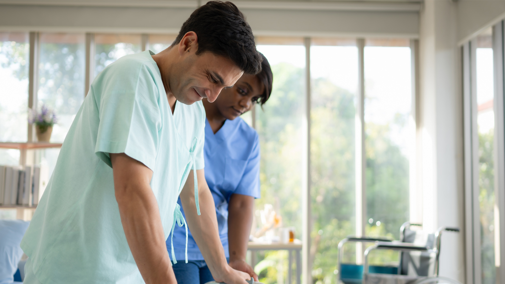 young-female-nurse-helping-young-male-patient-to-w-2023-11-27-05-37-12-utc