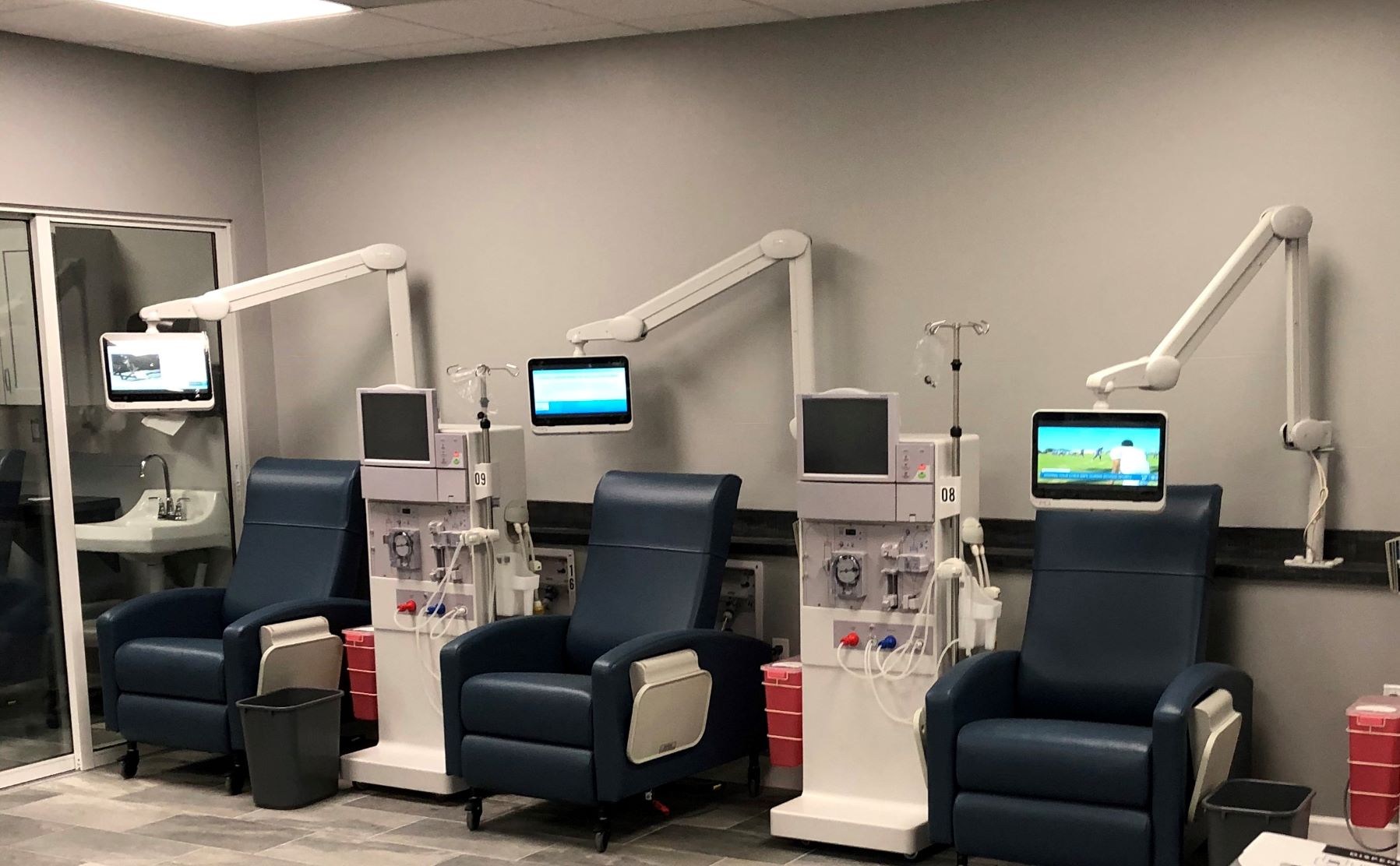 Three medTAB16s by  PDi Communication Systems, Inc, displayed on mounting arms chairside at a dialysis clinic