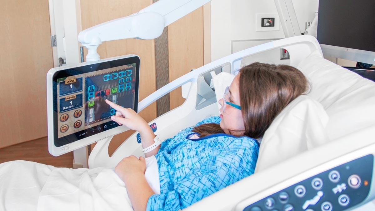 patient using PDi personal arm mounted TV